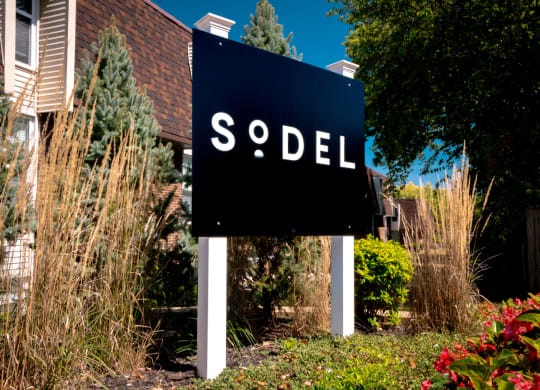 a sign in front of a house that says sold