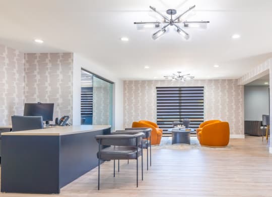 an office with a desk and chairs and a conference room