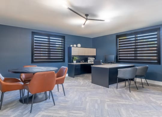 a dining room with blue walls and a table and chairs