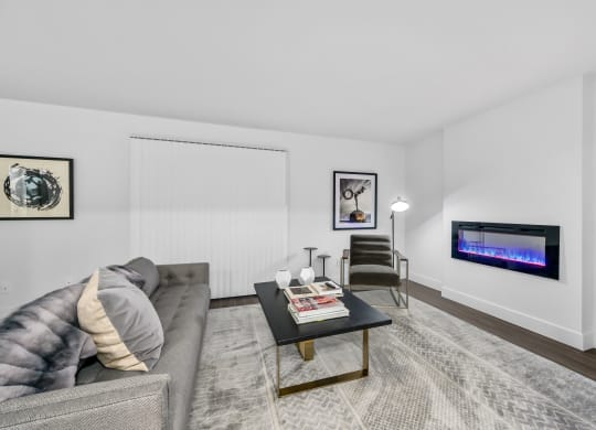 a living room with a couch coffee table and a fireplace