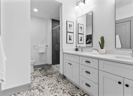 A bathroom with a white towel hanging on the door. at The Ridge Apartments, Cincinnati, OH