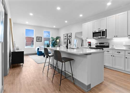 A kitchen with a white countertop and grey cabinets. at The Ridge Apartments, Cincinnati, OH