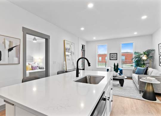 A modern kitchen with a white countertop and stainless steel appliances. at The Ridge Apartments, Cincinnati, Ohio