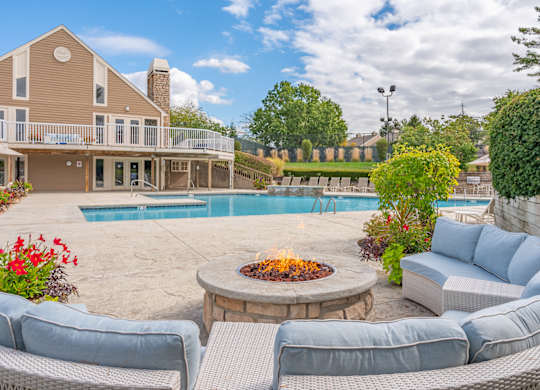 A house with a pool and a fire pit in the backyard.
