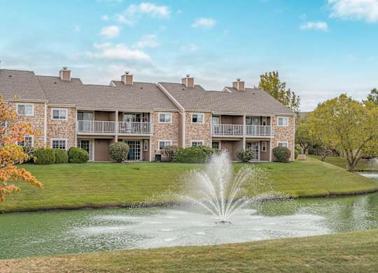 A large building with a fountain in front of it.