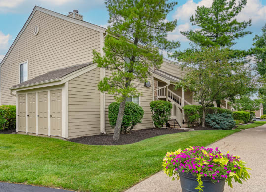 a house with a garage and a driveway with a potted plant on the side of the at Enclave, Beavercreek