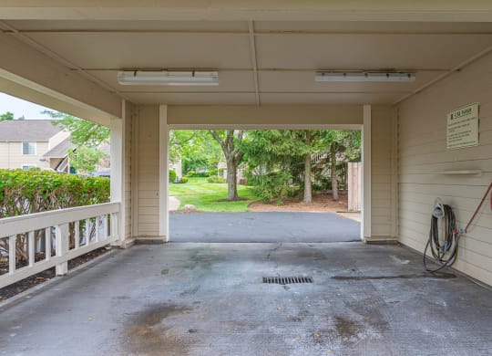 an empty garage with a driveway and trees in the background at Enclave, Beavercreek, Ohio