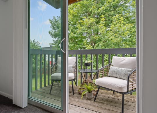 Balcony with two chairs and a table  at Timber Glen Apartments, Batavia, 45103