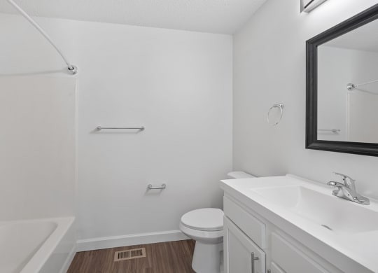 an empty bathroom with a sink toilet and bath tub