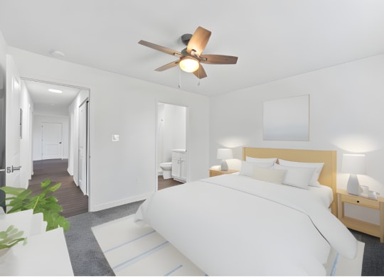 a white bedroom with a large bed and a ceiling fan