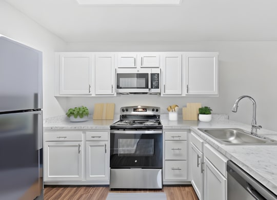 a kitchen with white cabinets and stainless steel appliances