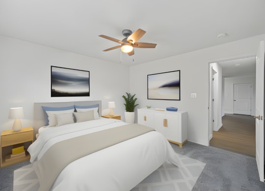a white bedroom with a large bed and a ceiling fan