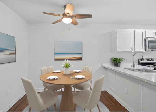 a kitchen and dining room with a table and chairs and a ceiling fan