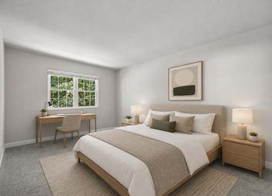 A bedroom with a large bed and a desk with a chair.