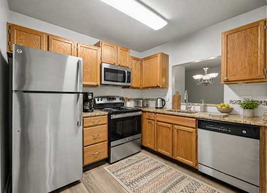 A kitchen with wooden cabinets and stainless steel appliances.