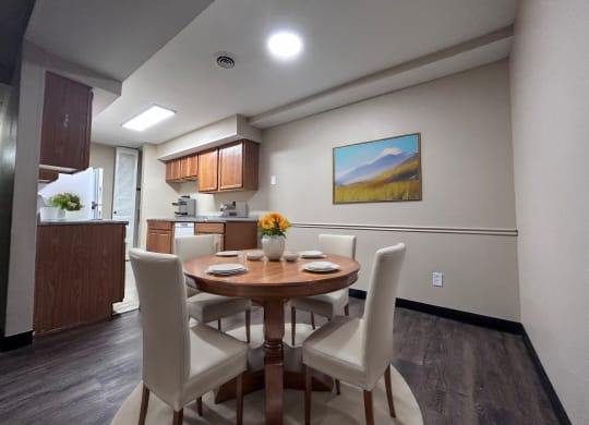 a dining room with a table and chairs and a kitchen