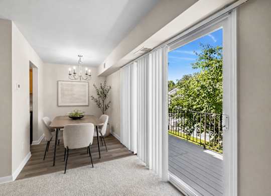 A dining room with a table set for four.