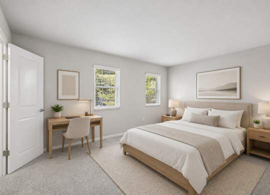 A bedroom with a bed, desk, and chair.