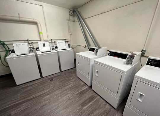 A row of washing machines in a laundromat.