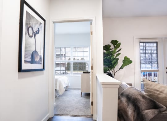 a bedroom with a large window and a door that leads to a bathroom  at Waterstone Landing, Ohio, 43551