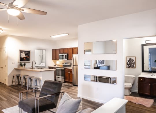 a living room with a couch and a chair and a kitchen with a sink and a toilet at Waterstone Landing, Perrysburg