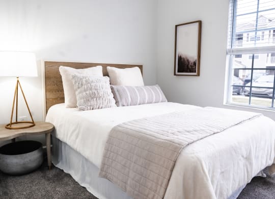a bedroom with a bed and a window  at Waterstone Landing, Ohio