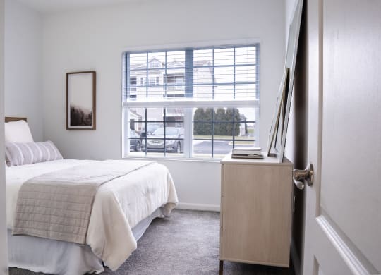 a bedroom with a bed and a large window at Waterstone Landing, Perrysburg, OH, 43551