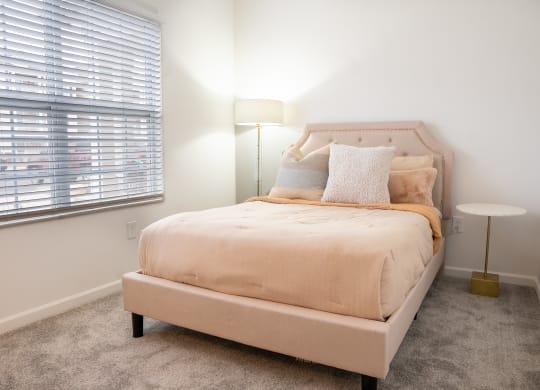 a bedroom with a bed and two windows  at Waterstone Landing, Perrysburg