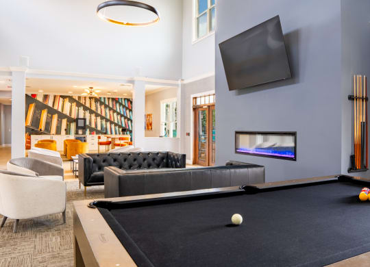 Living room with a pool table and a television at Waterstone Landing, Perrysburg, OH, 43551