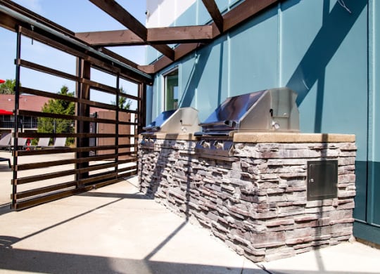 a patio with a grill and a wooden fence at 7 Pointe Apartments, Indianapolis, Indiana