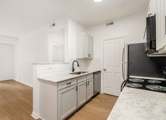 a renovated kitchen with white cabinets and a white counter top