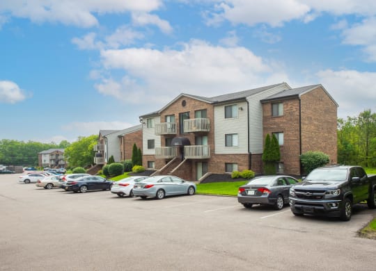 a parking lot with cars in front of an apartment building at The Woodridge Collection, Ohio, 45014