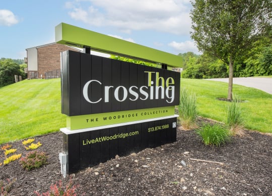 a sign for the crossing in front of a grass field at The Woodridge Collection, Ohio