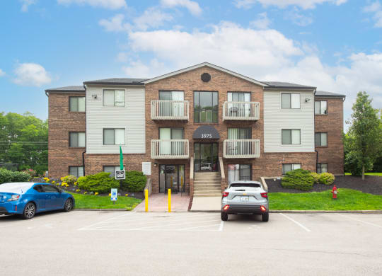 a large apartment building with cars parked in front of it at The Woodridge Collection, Ohio, 45014