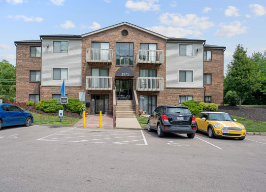 a large apartment building with a parking lot in front of it at The Woodridge Collection, Fairfield Ohio