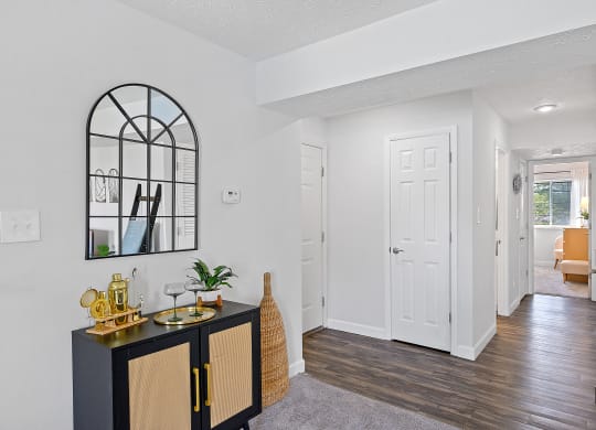 Living room and hallway with a black cabinet and a white door at Wrights Point, Ft Wright, KY
