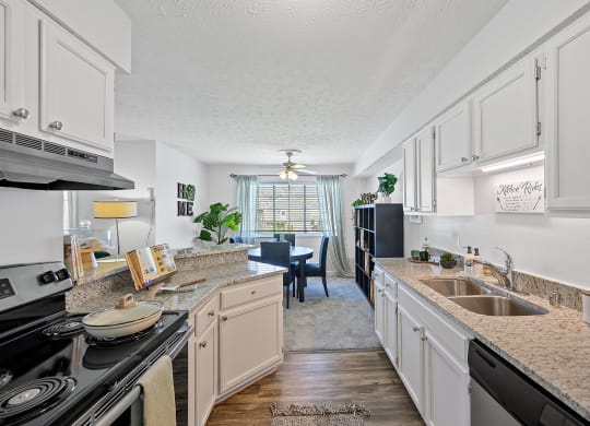 Spacious kitchen with granite counter tops and a dining room with a table and chairs at Wrights Point, 41011