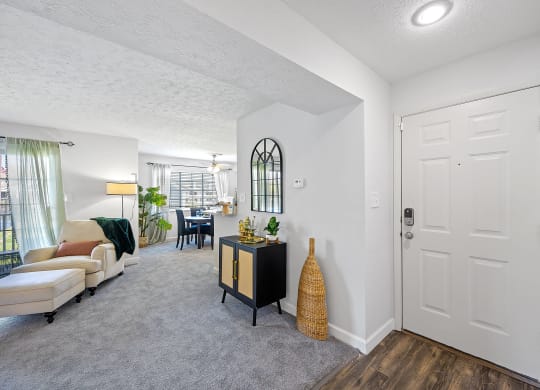 Open living room and dining room with a white door at Wrights Point, Ft Wright, KY