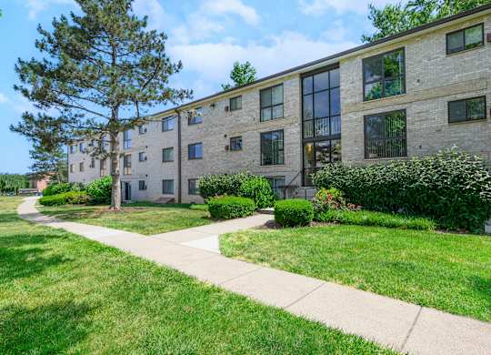 A building with a green lawn in front at Rose Hill Apartments, Virginia