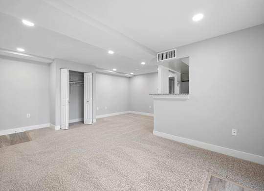 A spacious room with a carpeted floor and a doorway leading to another room at Rose Hill Apartments, Virginia, 22310