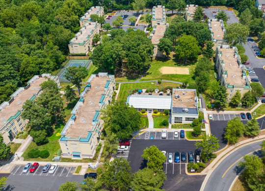 an aerial view of a neighborhood with cars parked in a parking lot