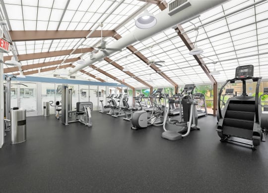 a gym with treadmills and other exercise equipment