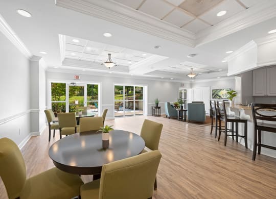 a large room with a table and chairs and a kitchen