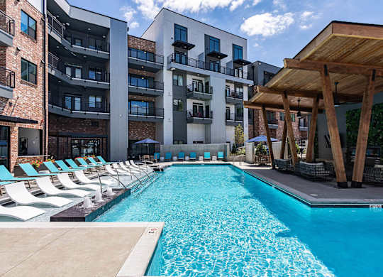A swimming pool in front of a modern apartment buildingat Sterling Nashville West Apartments, Tennessee