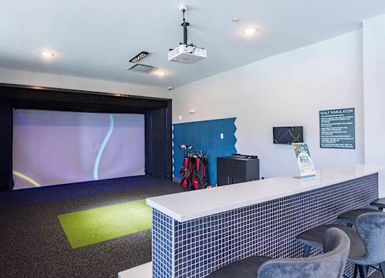 a room with a desk and a projection screenat Sterling Nashville West Apartments, Nashville