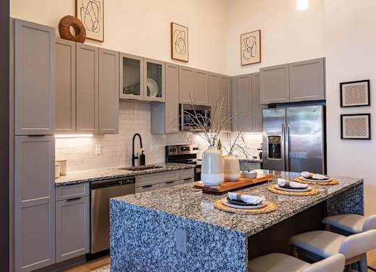 a kitchen with stainless steel appliances and a granite counter topat Sterling Nashville West Apartments, Tennessee, 37209