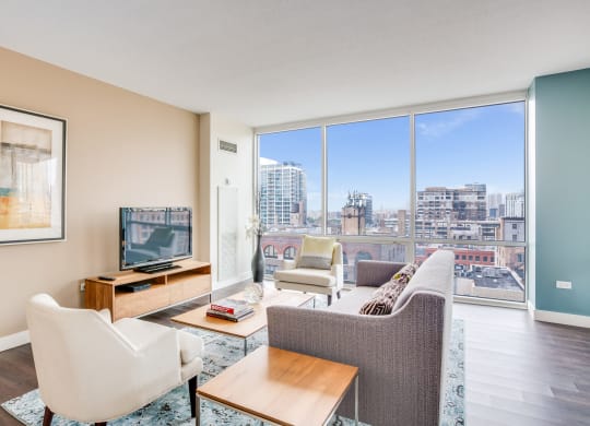 Model apartment with floor to ceiling window with city views at Flair Tower, Chicago, Illinois