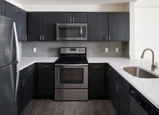 Espresso Cabinetry and White Countertops at The Manhattan Tower and Lofts, 1801 Bassett Street, Denver