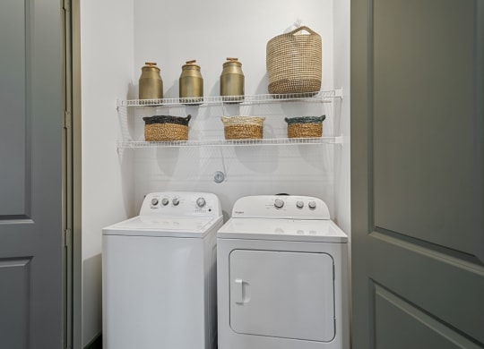 Washer and dryer in laundry room at The Lakeyard District