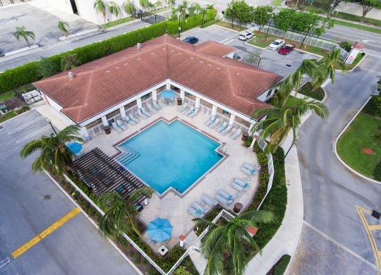 Aerial view of the the community pool and apartment building at Windsor Biscayne shores in North Miami